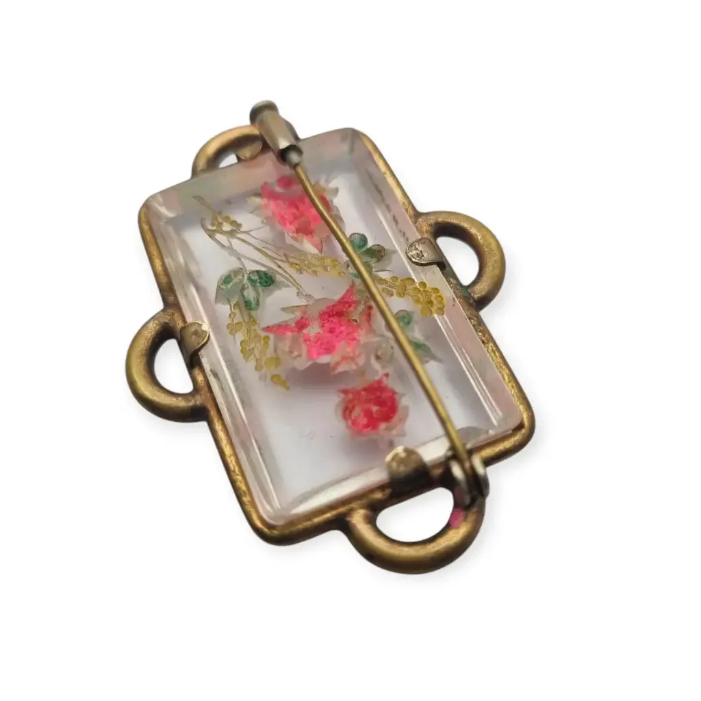Vintage rectangular Art Deco brooch with lucite flowers from the 1940s.