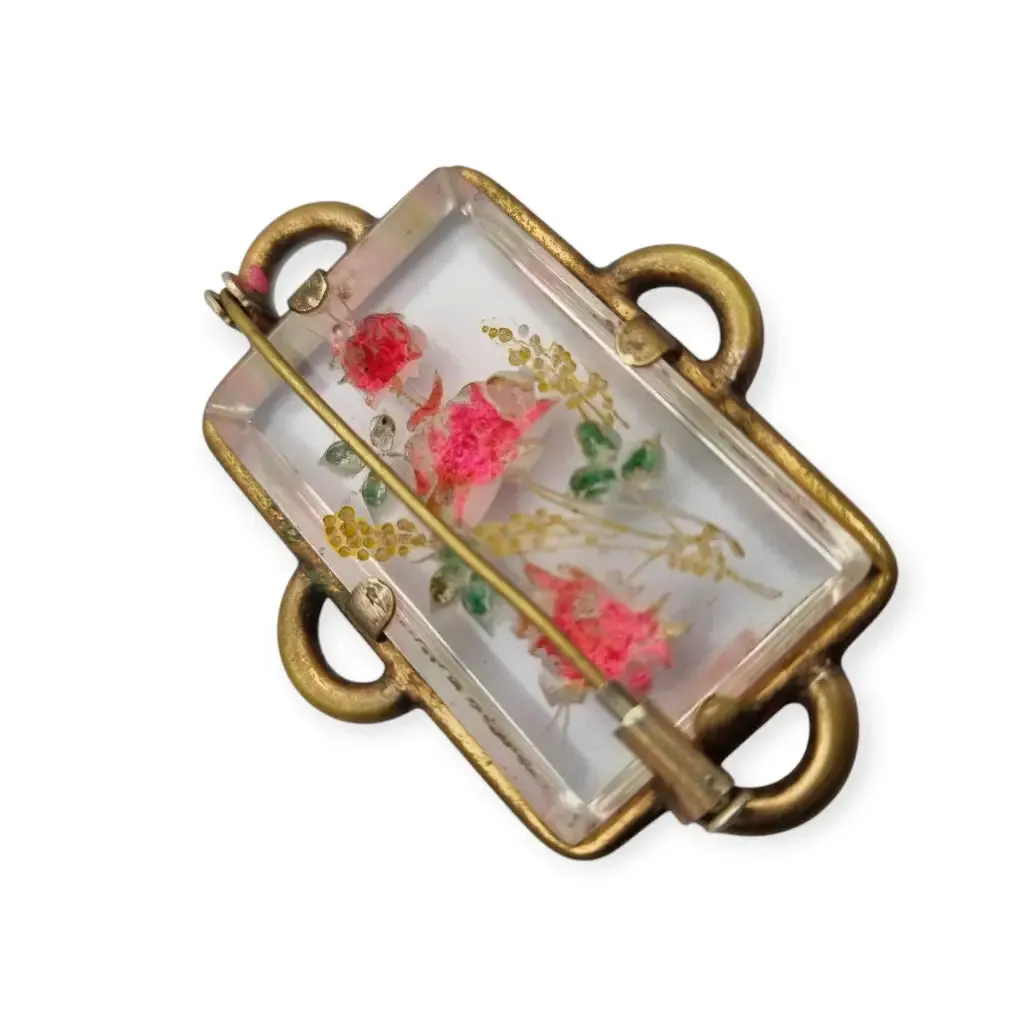 Vintage rectangular Art Deco brooch with lucite flowers from the 1940s.