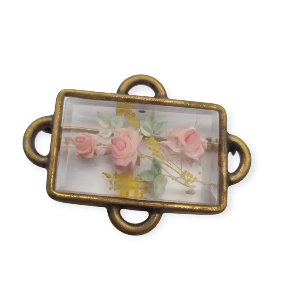 Vintage rectangular Art Deco brooch with lucite flowers from the 1940s.